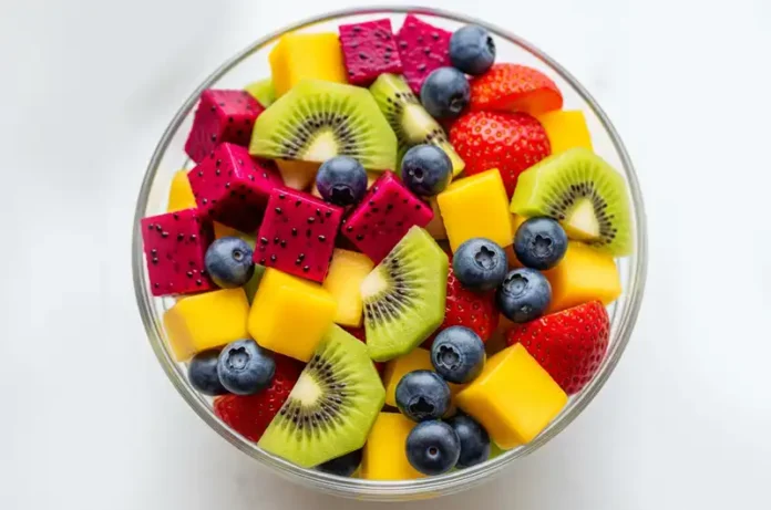 Delicious fruit salad featuring diced red dragon fruit, showcasing one of many tasty ways to eat it.