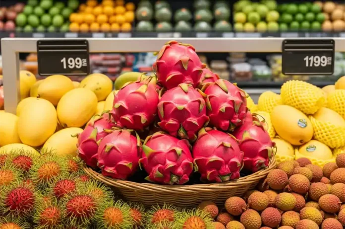 Red dragon fruit displayed in a supermarket's tropical fruit section, showing where it can be bought.